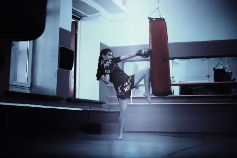 Un luchador de artes marciales mixtas entrenando en un gimnasio profesional.