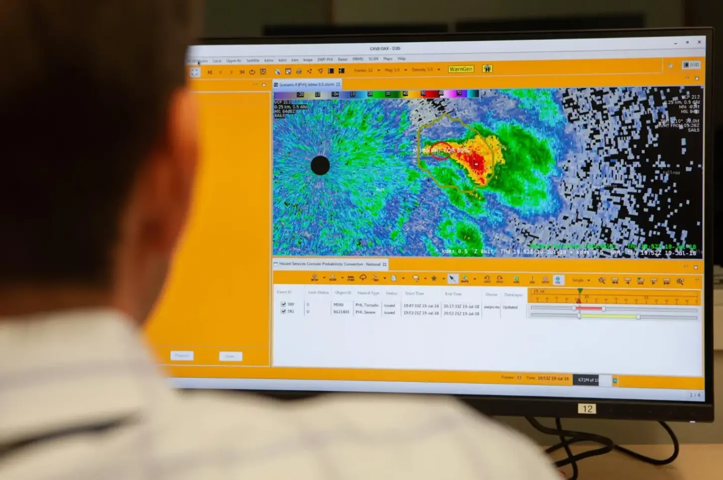 Monitores de ordenador en un laboratorio mostrando gráficos meteorológicos.